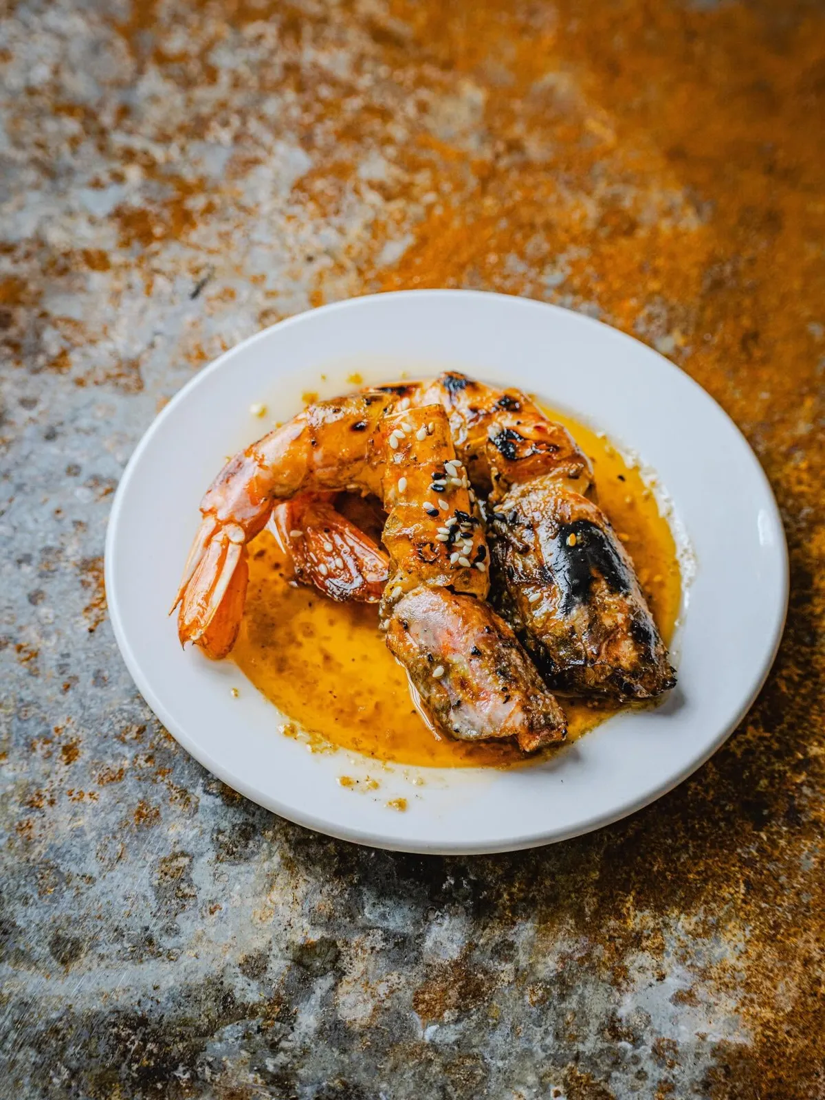 Charcoal-grilled prawns with garlic butter, homemade chilli oil and lime