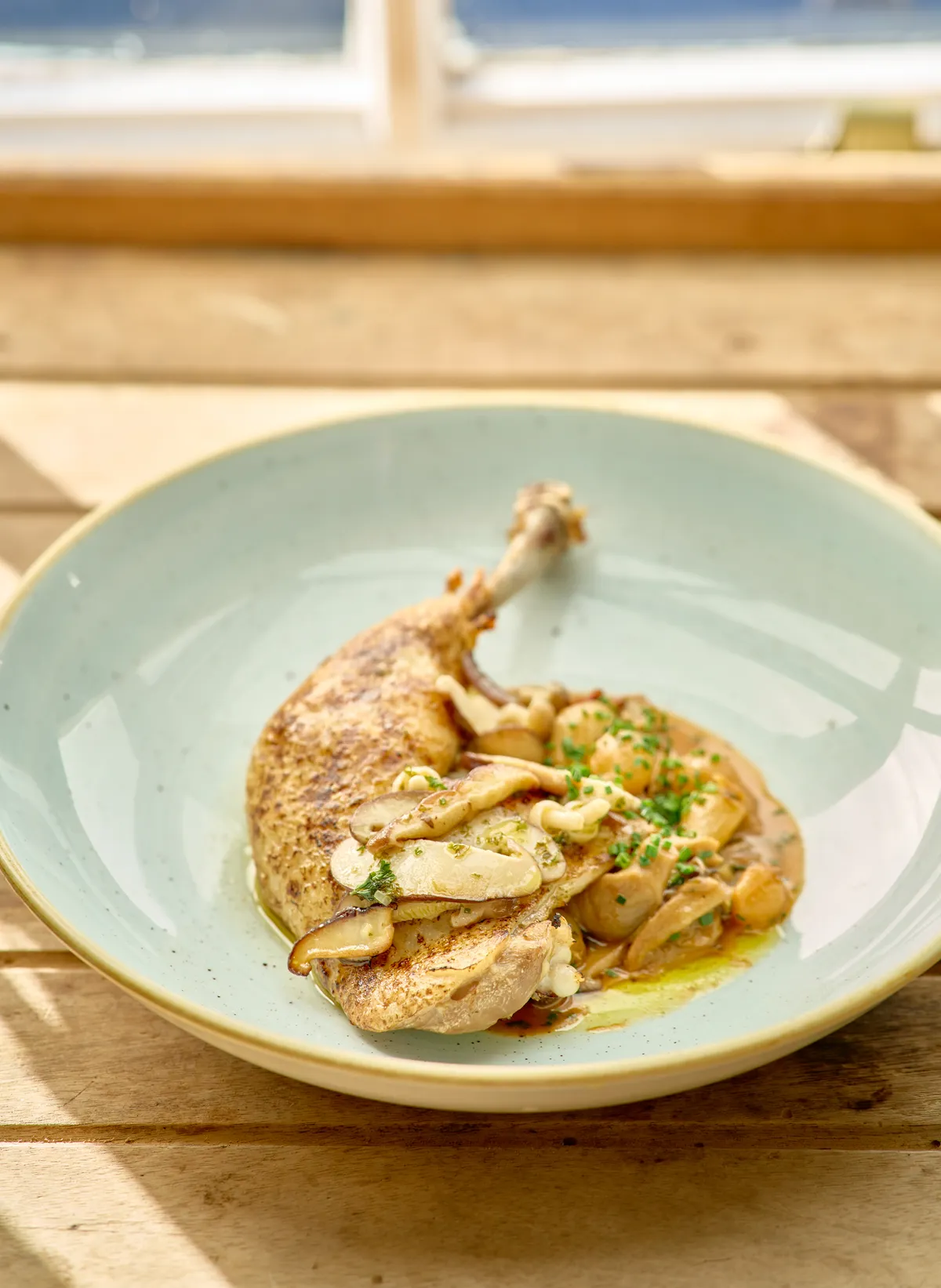 Confit chicken leg with mushrooms and a light cream sauce