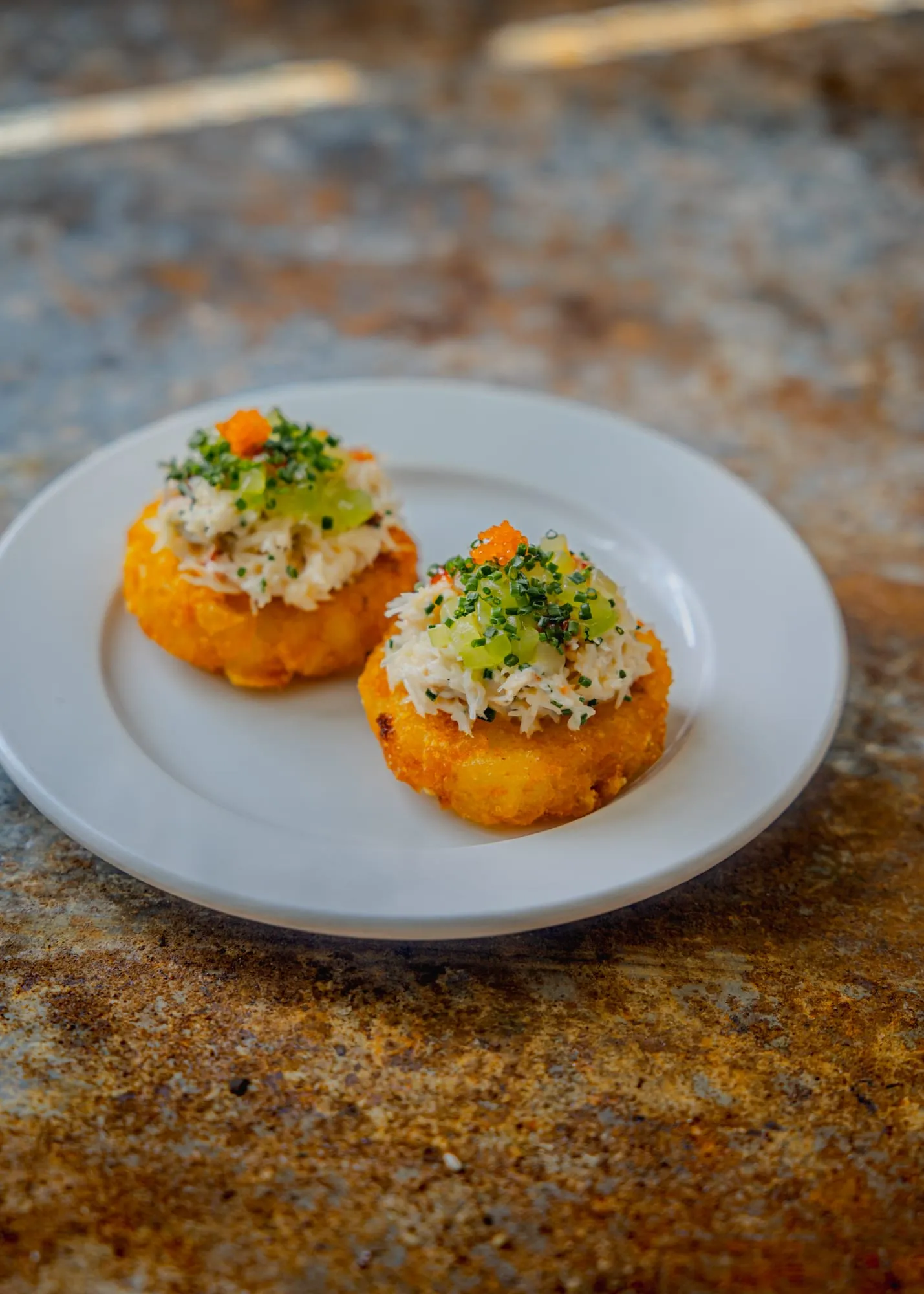 Cornish hand-picked crab on a potato rösti with cucumber, sriracha and yuzu gel