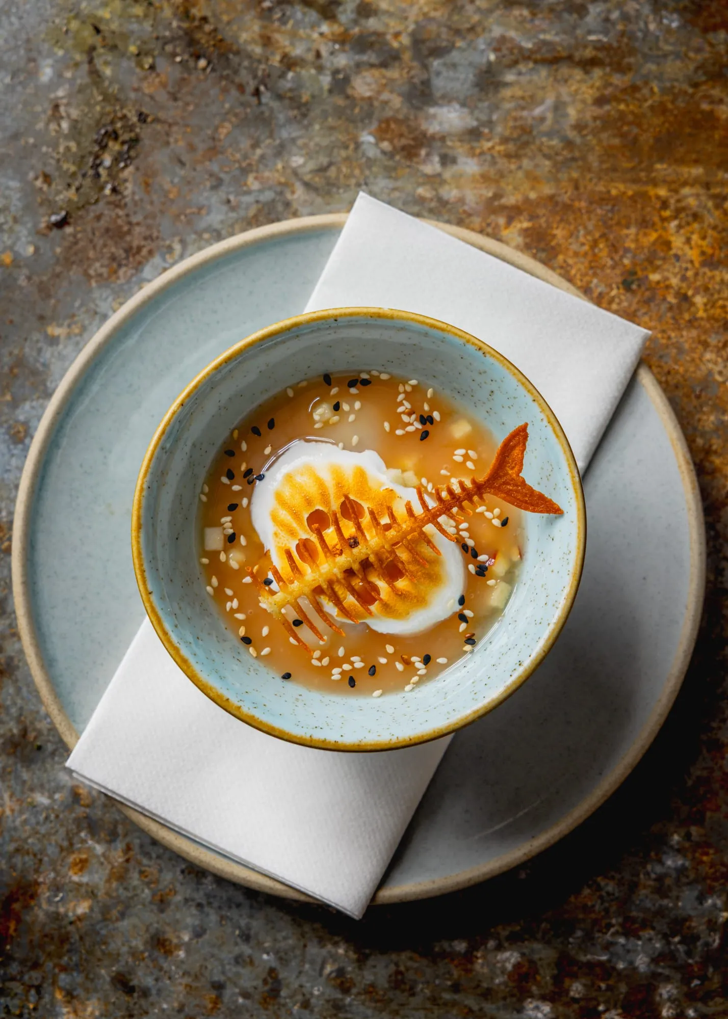 Lychee floating island with Italian meringue, mango, toasted sesame and sweet tuiles