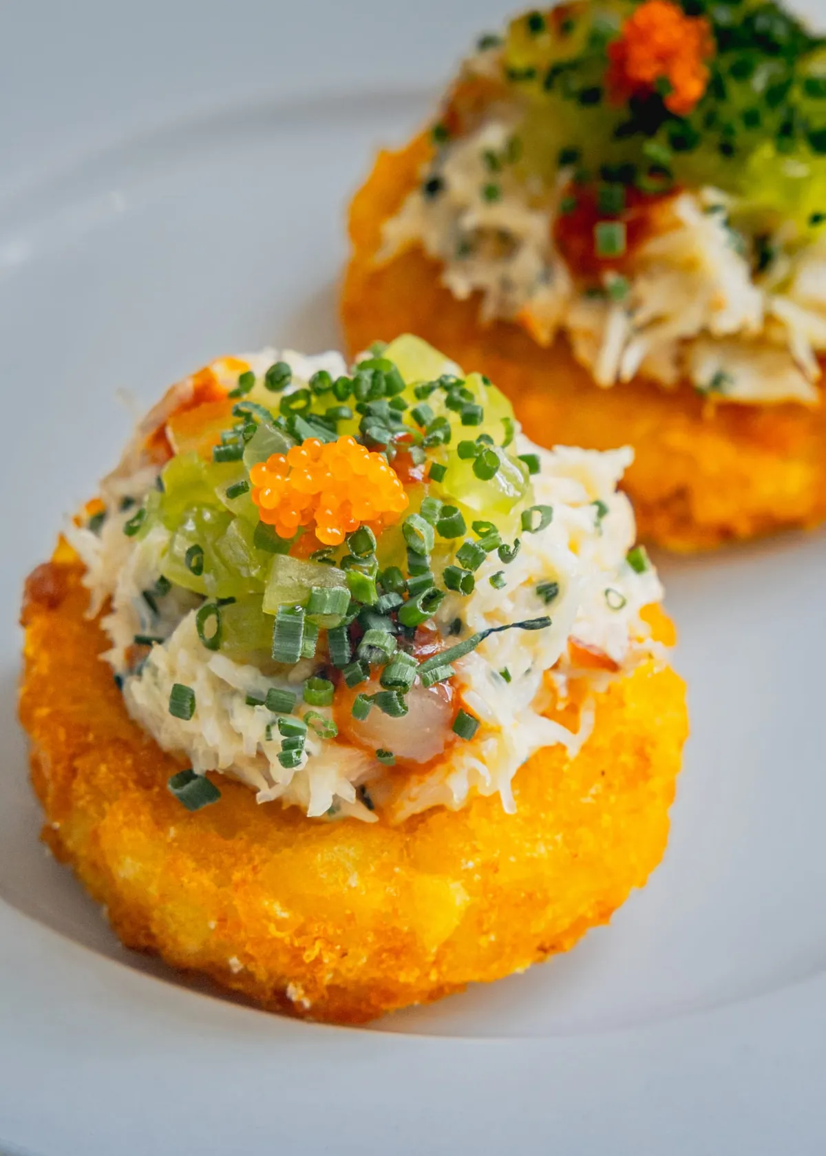 Close-up of Cornish hand-picked crab on a crisp potato rösti with chives and Tabiko