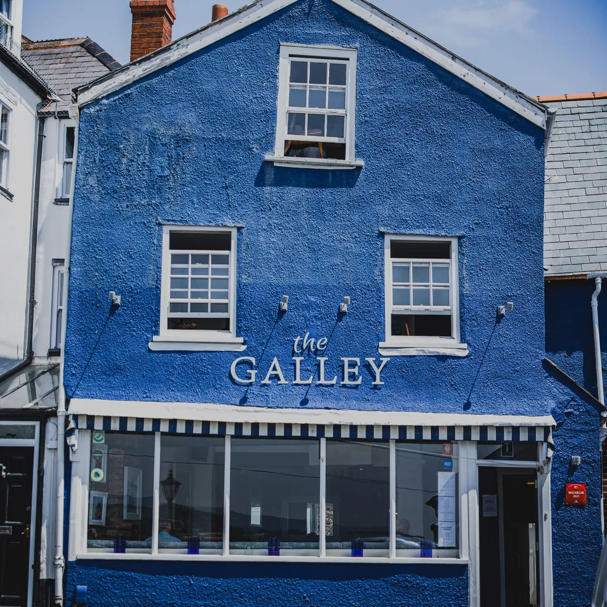 The Galley's blue-painted shopfront and hanging sign on Fore Street, Topsham