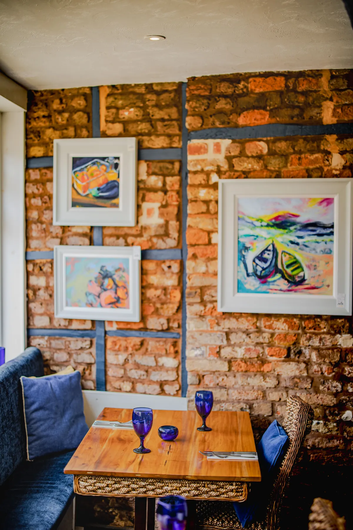 The Galley dining room — exposed brick wall with local artwork