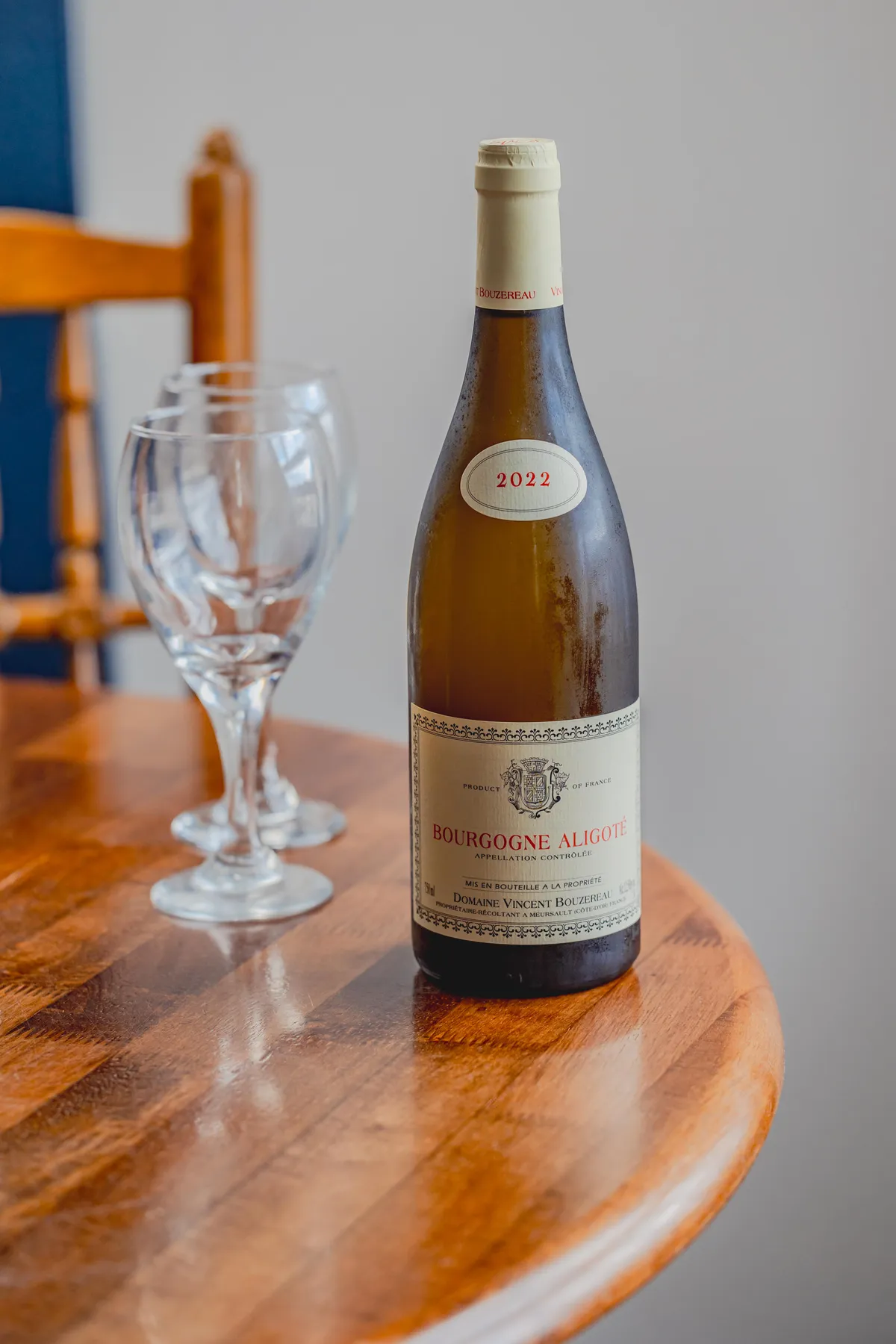 A bottle of Bourgogne Aligote on a wooden table