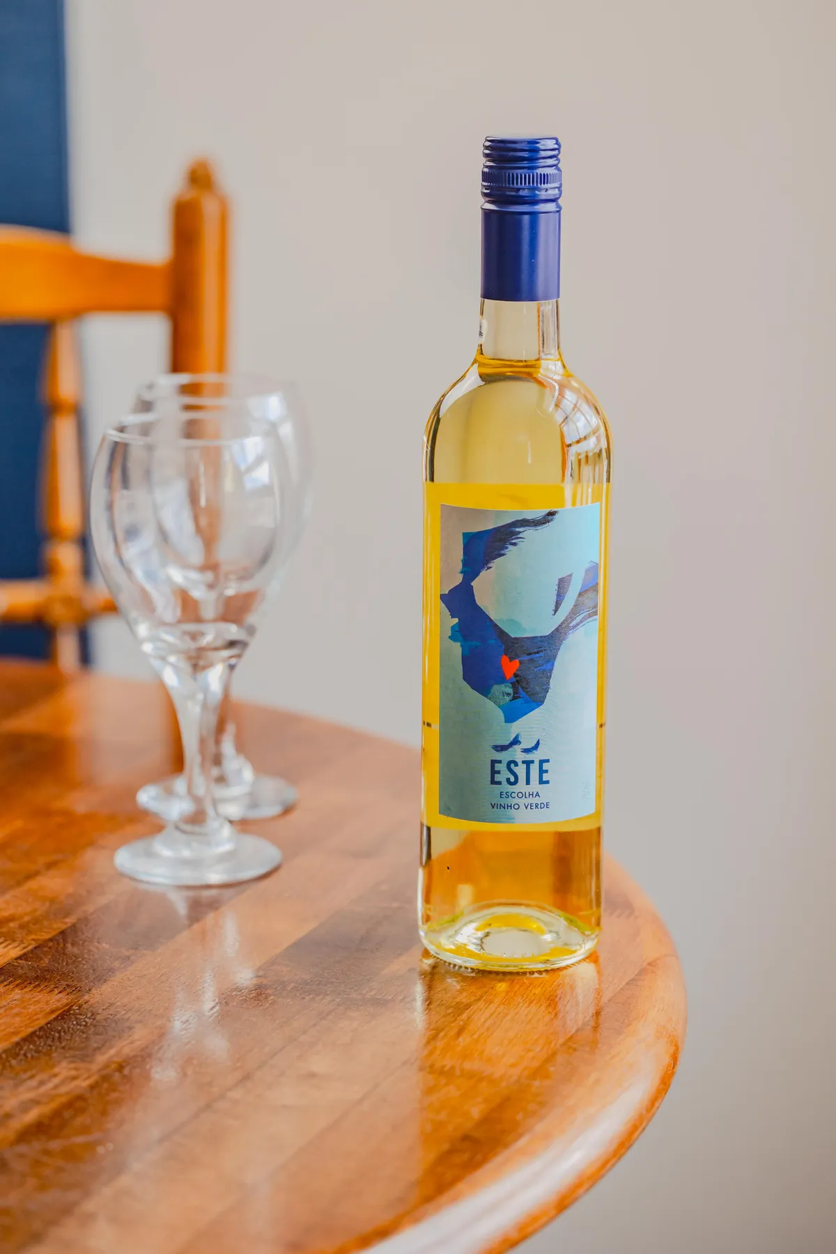 A bottle of ESTE Vinho Verde on a wooden table
